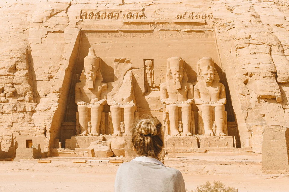 Person sat in front of Abu Simbel Temple entrance in Egypt