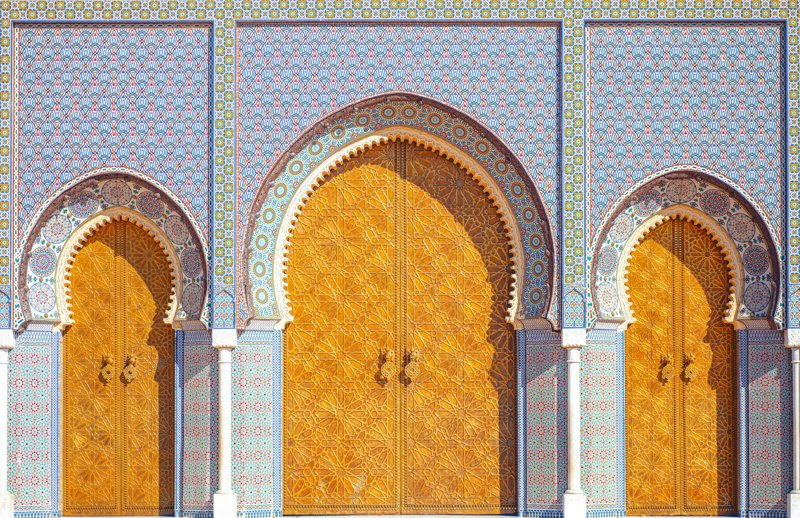 Traditional orange doors and colourful mosaic walls with small pillars