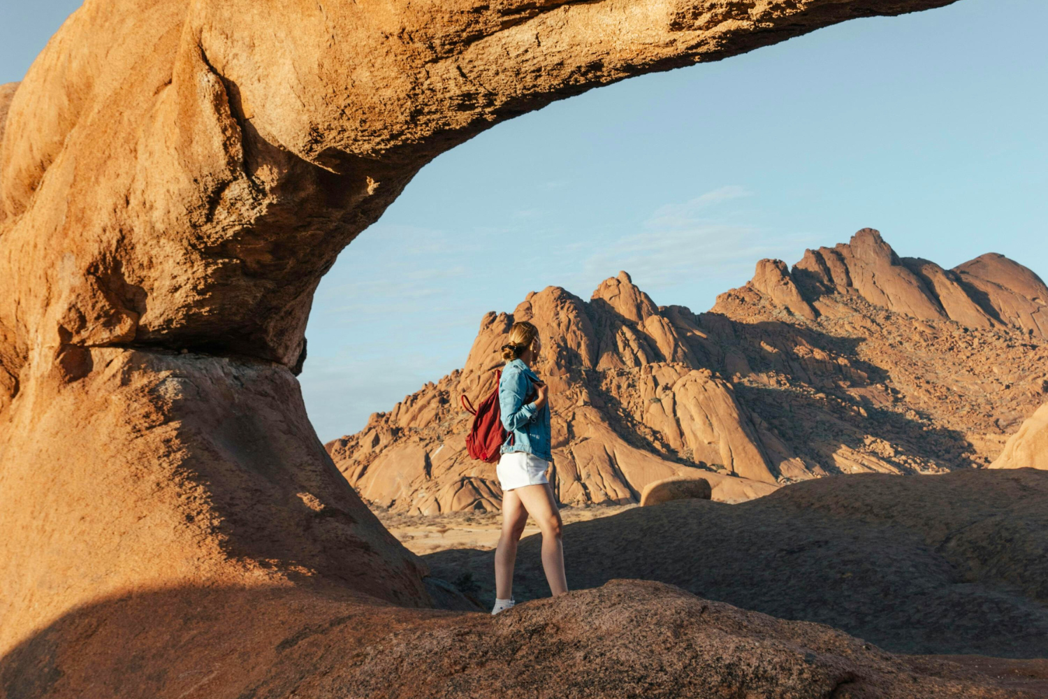 Traveller standing aming the rock formations in the Erongo Mountains in Namibia
