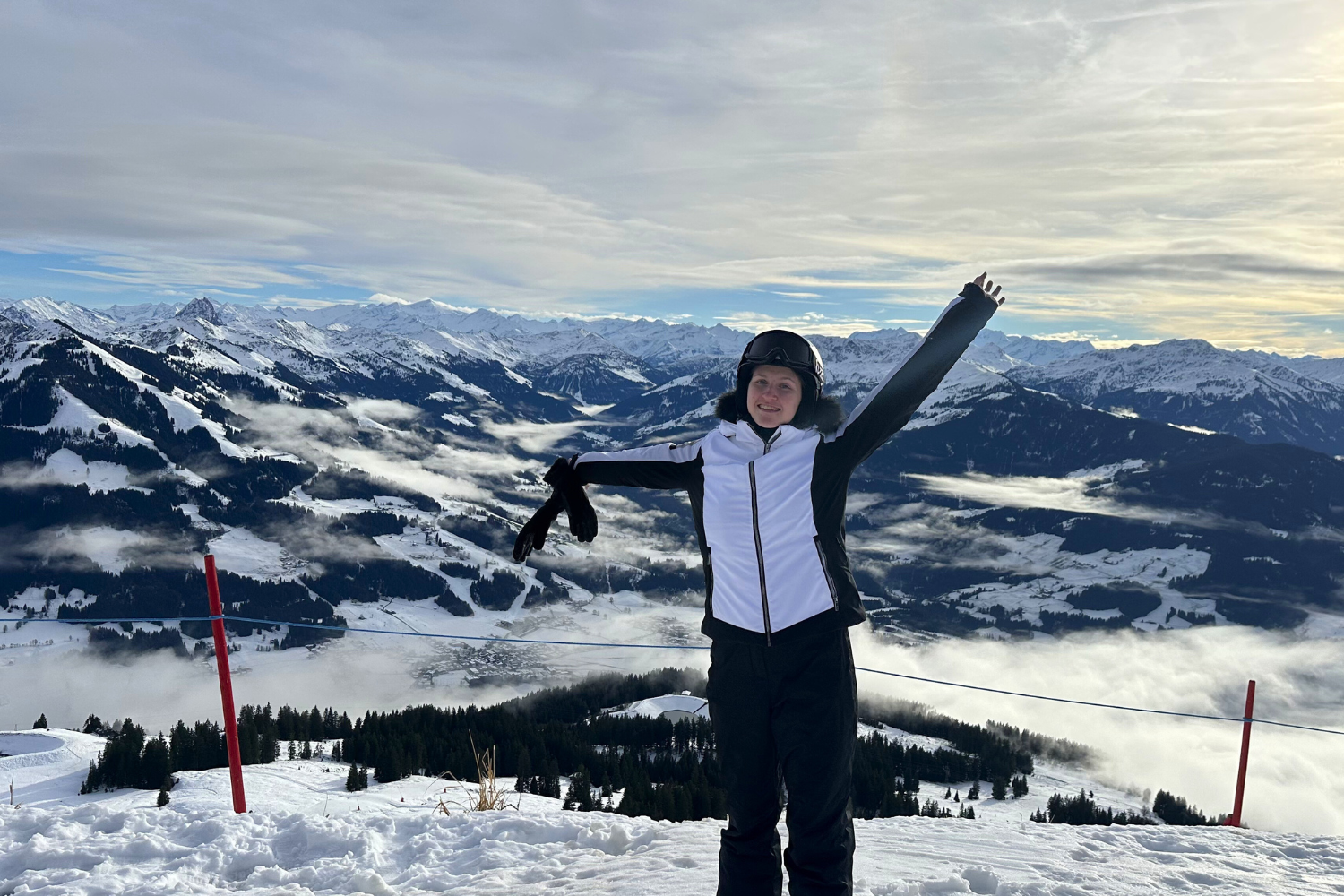 Traveller with arms in the air after a day skiing in the snowy Austrian Alps