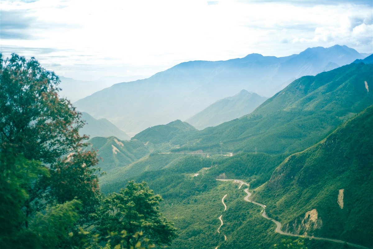 Winding roads through densely forested mountains in O Quy Ho pass, Sa Pa, Vietnam