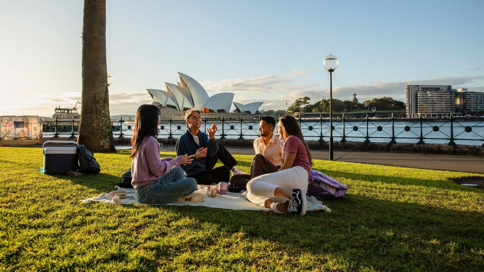 Travellers enjoying picnic near Sydney Harbour
