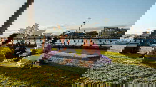 Travellers enjoying picnic near Sydney Harbour