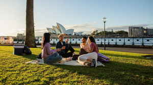 Travellers enjoying picnic near Sydney Harbour