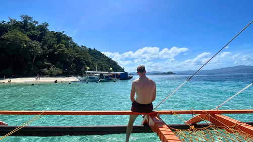 Solo travellers sat on boat in the Philippines