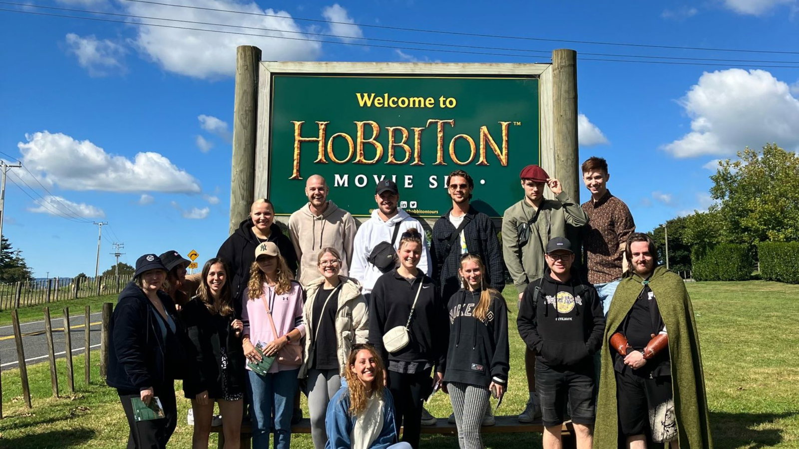 Group of traveller at Hobbiton Movie Set sign