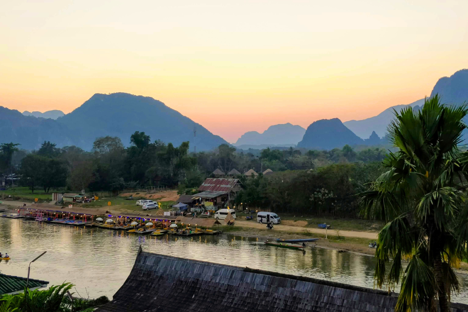 Landscape of Nam Song River in Vang Vieng, surrounded by mountains, at sunset, in Laos
