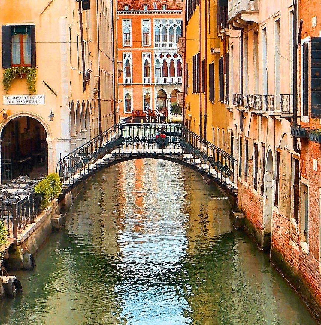 Stepped bridge over a canal road in Venice Italy