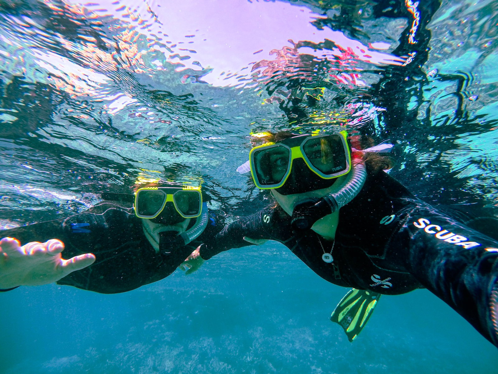 Two divers underwater taking a selfie