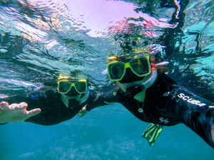 Two divers underwater taking a selfie