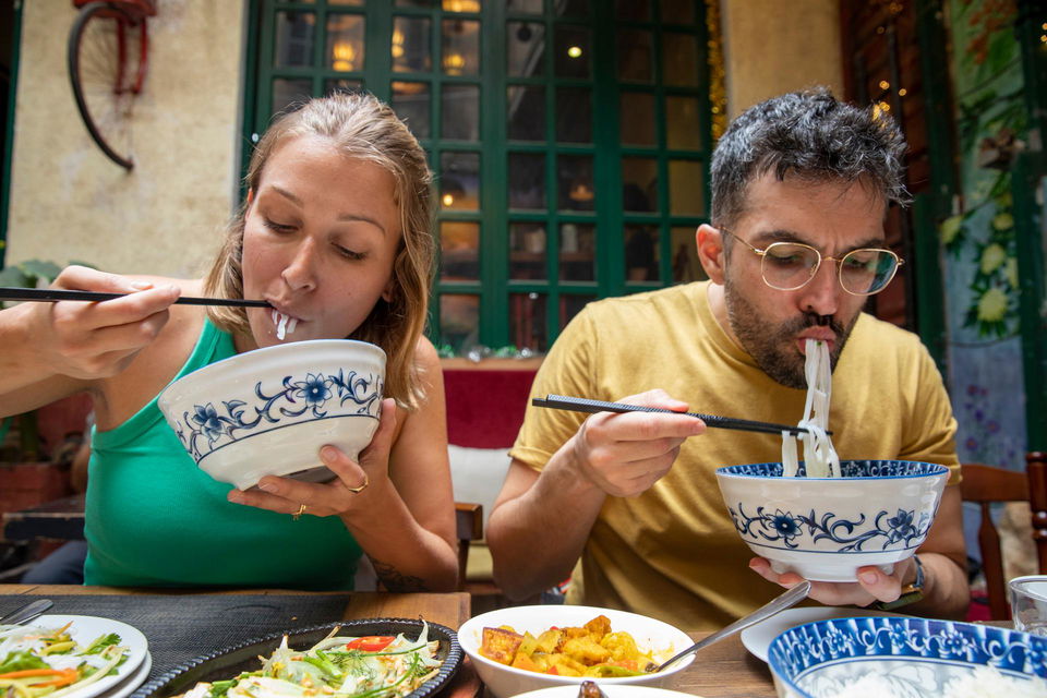People eating Pho Soup in Hanoi Vietnam