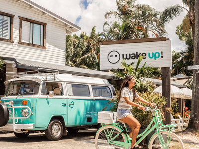 Woman on bike in front of wake up accommodation