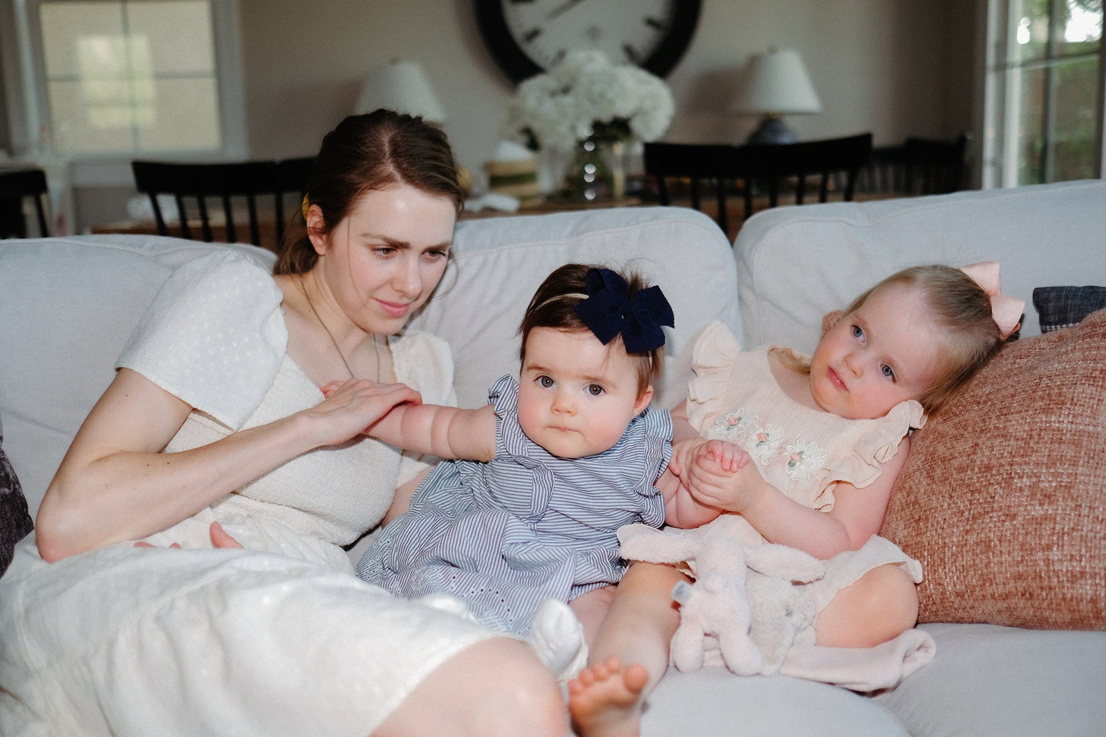 Person sitting on a sofa with two children