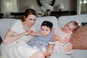 Person sitting on a sofa with two children