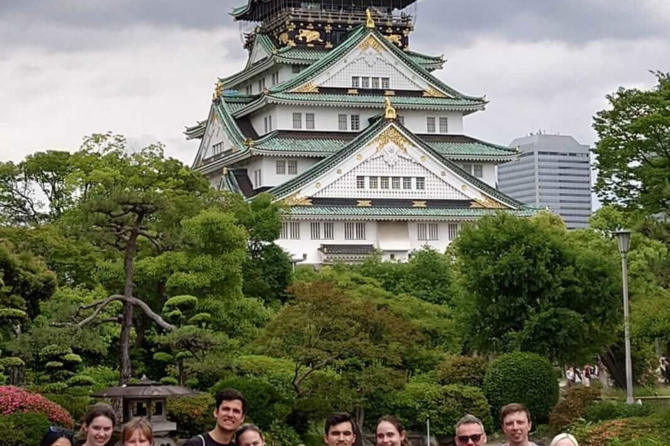 Travellers under osaka castle in japan
