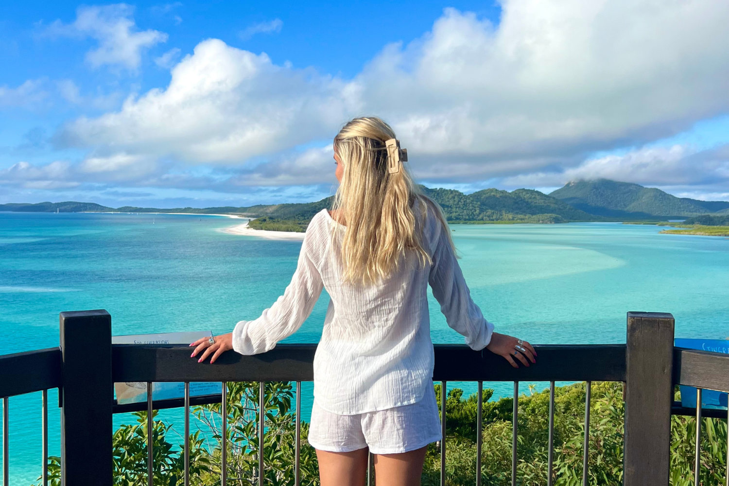 Traveller looking across Whitehaven Beach viewpoint in Australia
