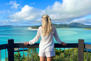Traveller looking across Whitehaven Beach viewpoint in Australia