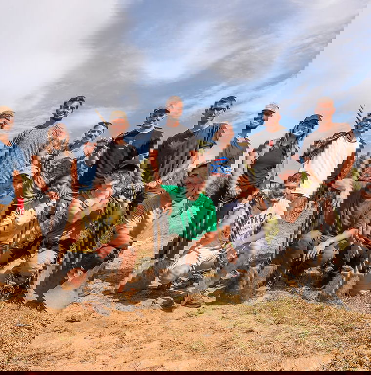 A group of travellers holiding shovels and picks