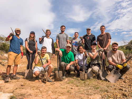 A group of travellers holiding shovels and picks