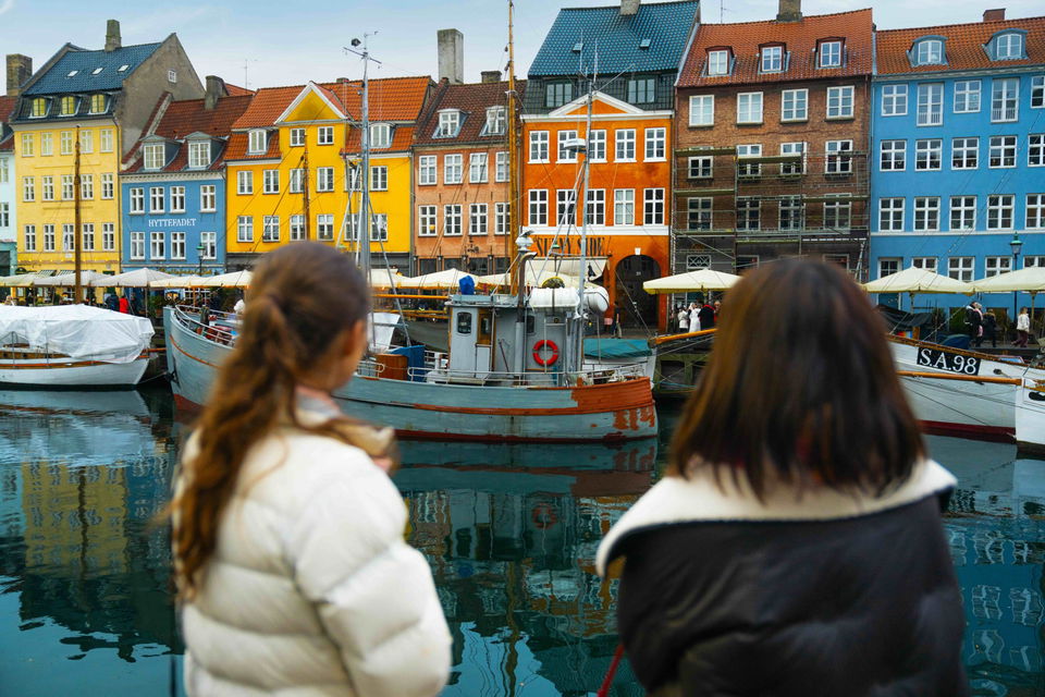 Group travellers looking at colourful buildings in Norway