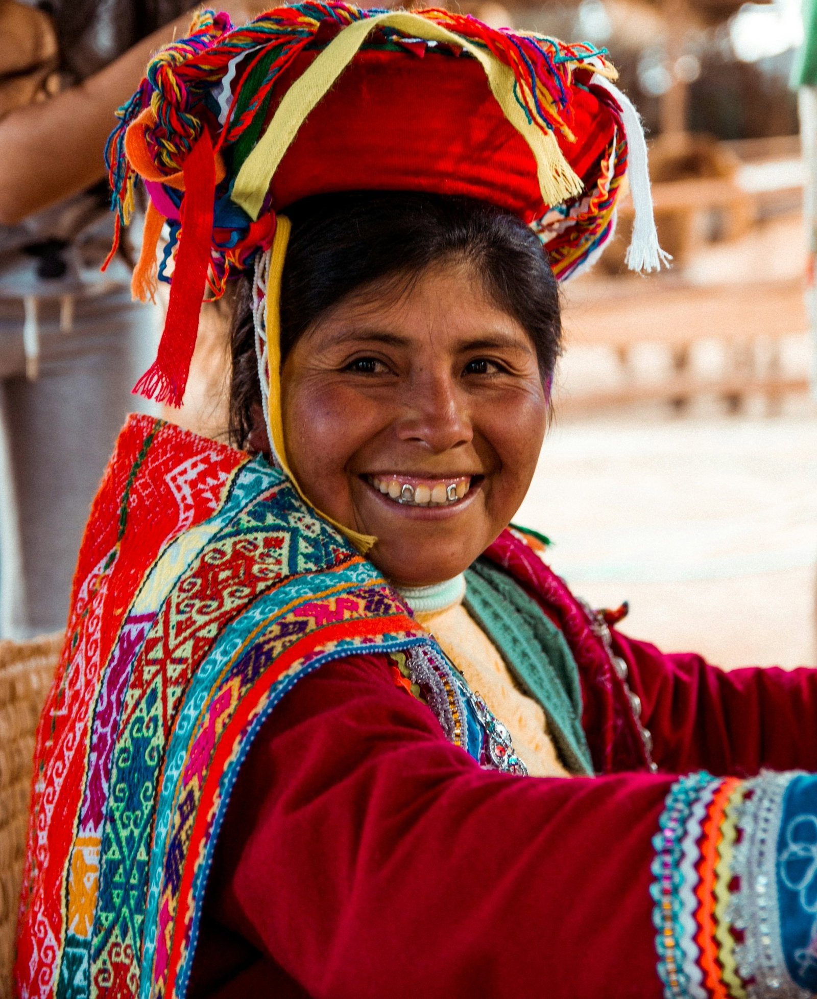 Woman dressed in colourful, traditional clothing and smiling, Peru