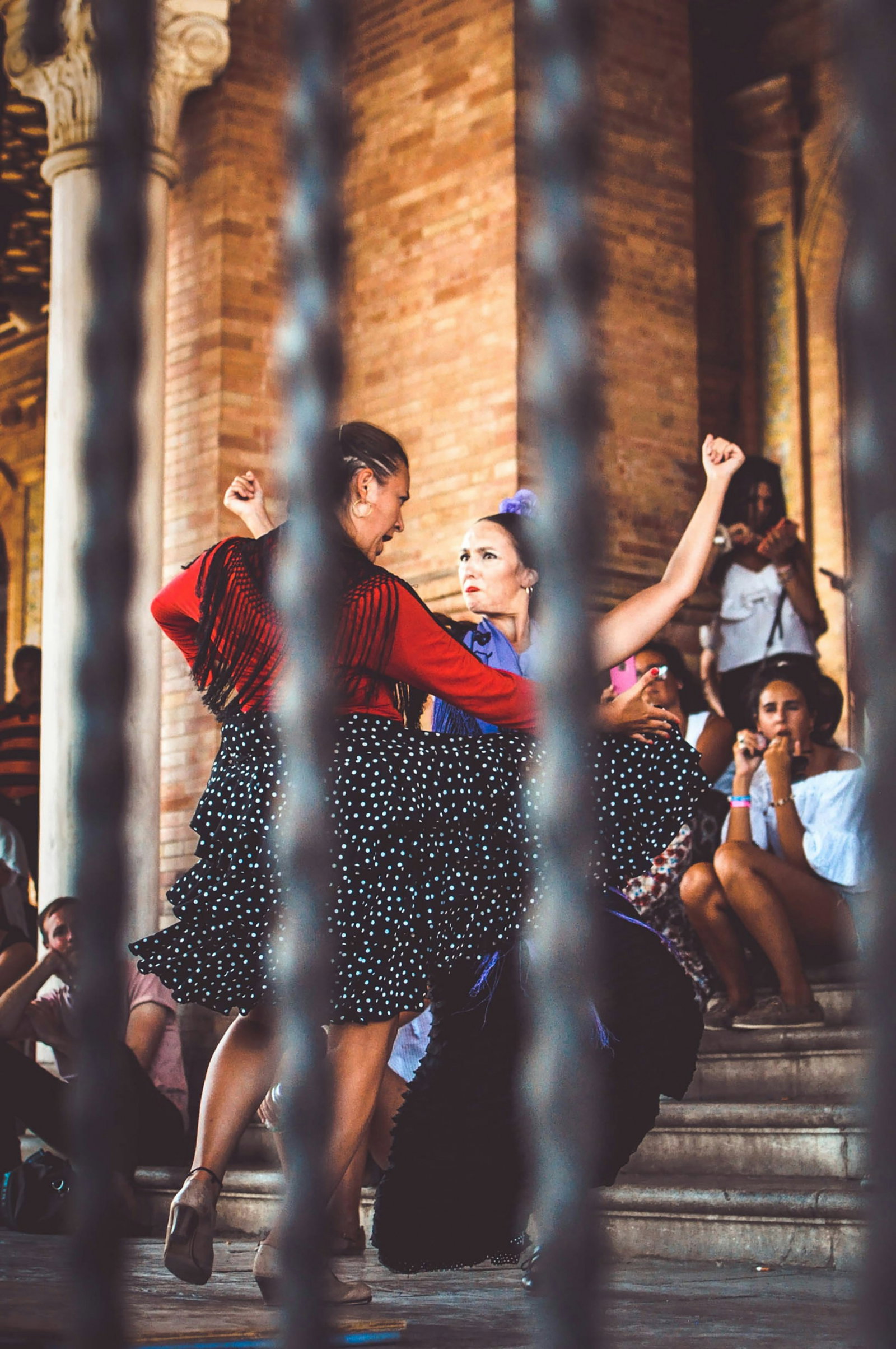 Two women flamenco dancing in Spain with crowd watching